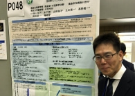 Image of researcher in front of poster